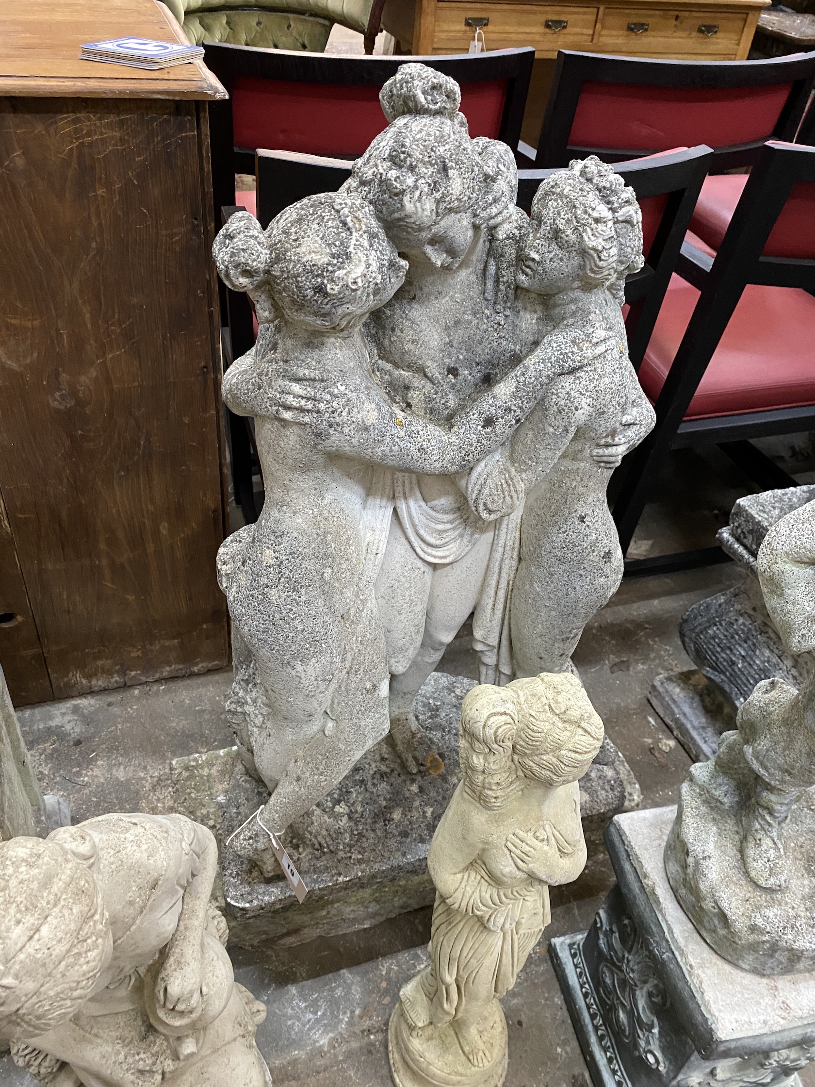 A reconstituted stone garden statue 'The Three Graces', on rectangular plinth, height 100cm